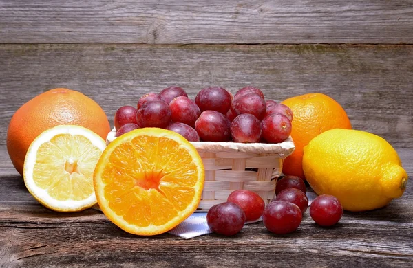 Assortment of fruits on a wooden background — Stock Photo, Image