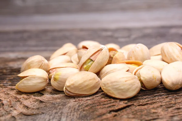 Roasted pistachios on wooden background — Stock Photo, Image