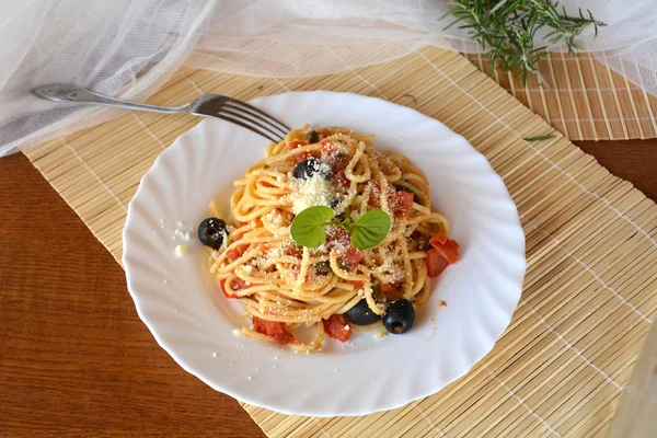 Spaghetti a la puttanesca op een kom. Italiaans eten. — Stockfoto