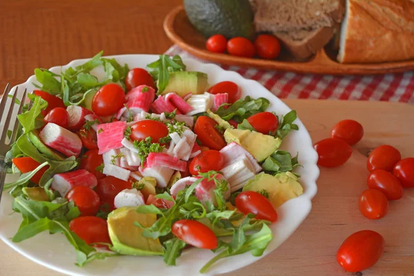 Mixed vegetable salad with crab sticks and avocado — Stock Photo, Image