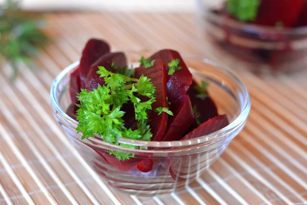 Fresh sliced organic beet root with parsley on a glass bowl — ストック写真
