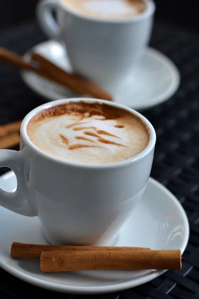 Cup of delicious foamy cappuccino on the black background — Stock Photo, Image