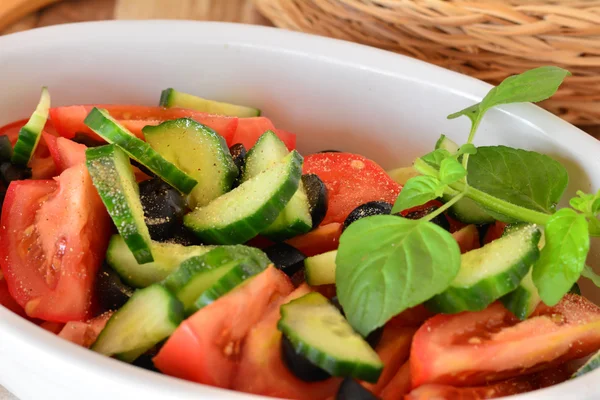 Ensalada de verduras saludables con pepino, tomates en un tazón de porcelana blanca — Foto de Stock