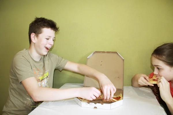 아이들은 식탁에 피자를 먹습니다 — 스톡 사진