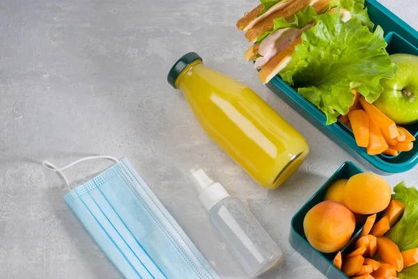 对细菌和病毒的卫生和保护 美味的学校午餐 午餐盒与三明治 新鲜蔬菜和水果 一瓶果汁的轻背景 平躺在床上 — 图库照片