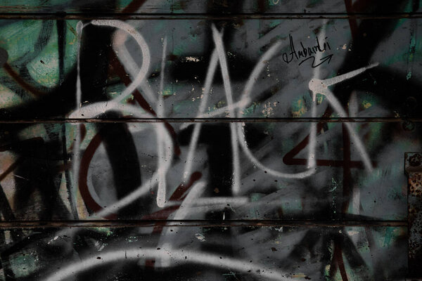Urban Graffiti on Weathered Metal Wall with Dark Grunge Texture