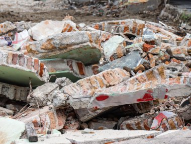 Broken Concrete Wall Debris with Exposed Rebar and Bricks, Ruined Building Structure After War Conflict or Forced Eviction, Destructive Urban Decay and Rubble Pile on Demolition Site