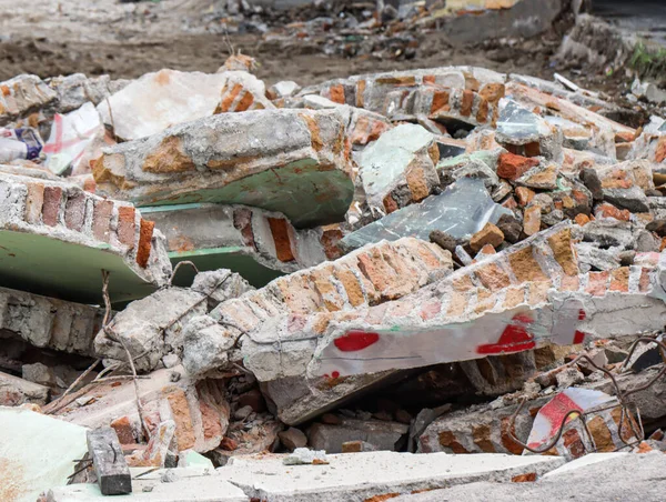 Broken Concrete Wall Debris with Exposed Rebar and Bricks, Ruined Building Structure After War Conflict or Forced Eviction, Destructive Urban Decay and Rubble Pile on Demolition Site