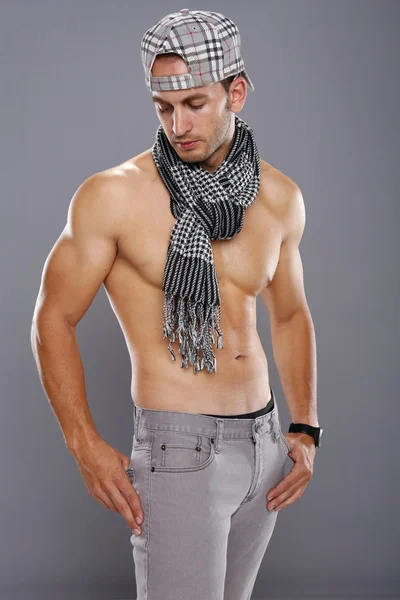 Athletic young man in scarf and cap — Stock Photo, Image