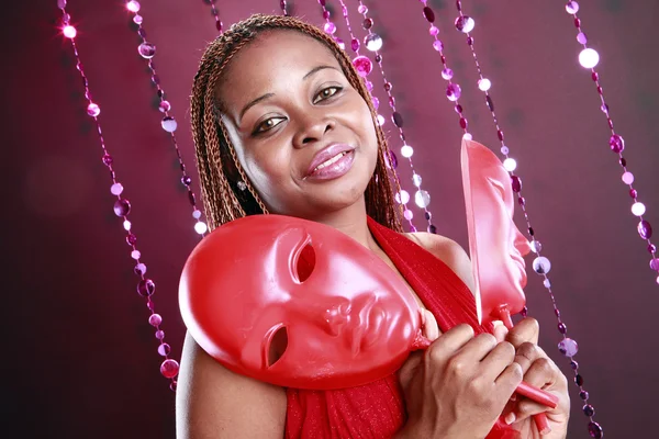 Young caribbean woman with red mask — Stock Photo, Image