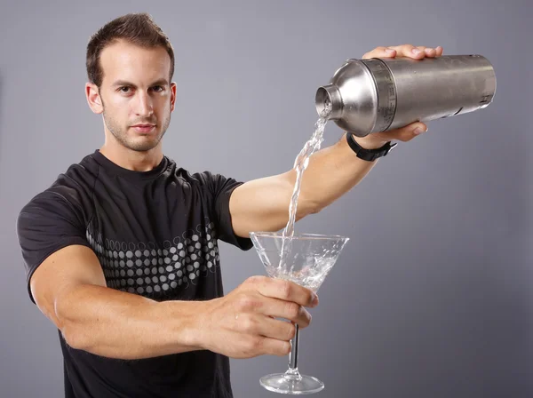 Young man pours himself a martini — Stock Photo, Image