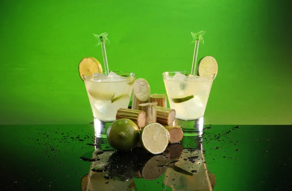 Caipirinha with sugar cane and lime — Stock Photo, Image