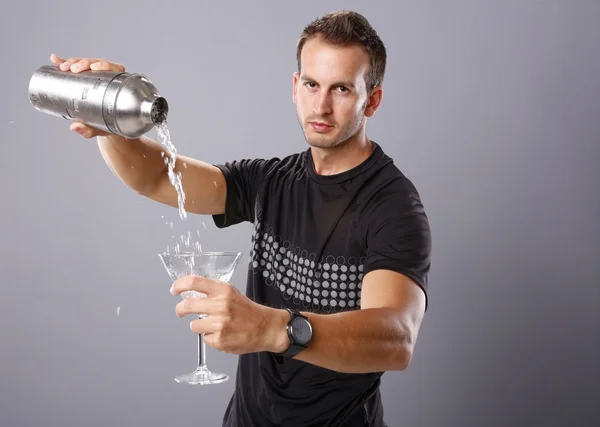 Young man pours himself a martini — Stock Photo, Image