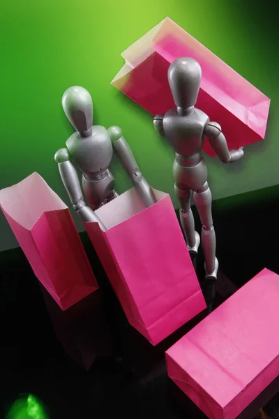 Silver dummies carrying gift bags — Stock Photo, Image