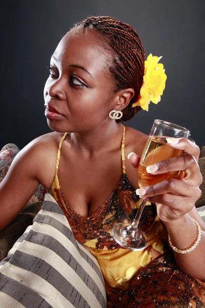 Young caribbean woman drinks champagne — Stock Photo, Image