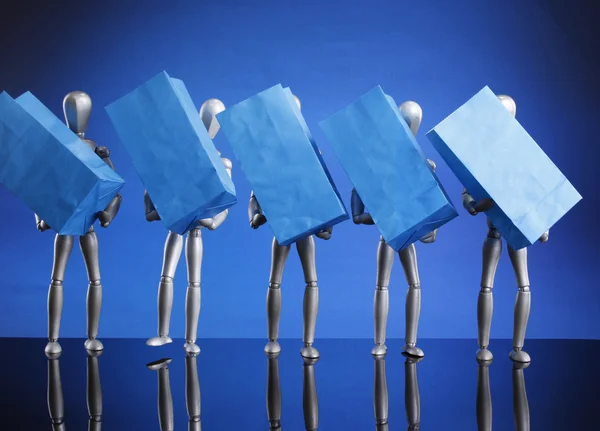 Dummies carrying gift bags — Stock Photo, Image