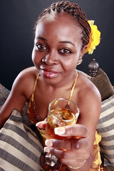 Young caribbean woman drinks champagne — Stock Photo, Image