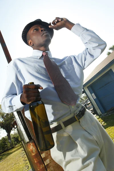 Man in gangster style with bottle — Stock Photo, Image