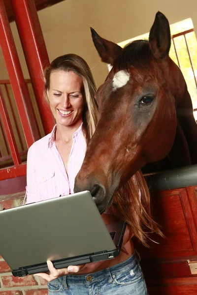 Girl and her horse check their social media site — Stock Photo, Image