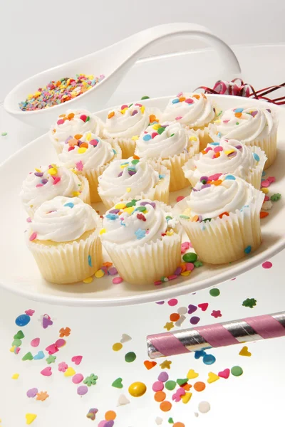 Snow white sprinkled fresh cupcakes — Stock Photo, Image