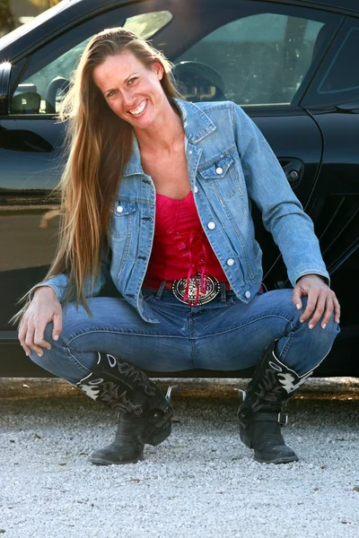 Texas blonde girl near a sport car — Stock Photo, Image