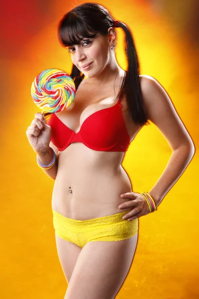 Sexy brunette girl with lollipop — Stock Photo, Image