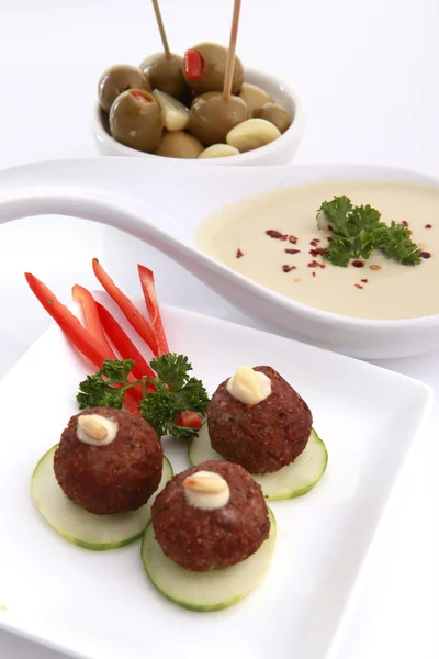 Fried kibbe, pitted olives and hummus tahine — Stock Photo, Image