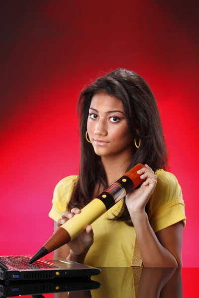 Girl working on laptop with big pencil — Stock Photo, Image