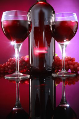 Red wine bottle with glasses and grapes clipart