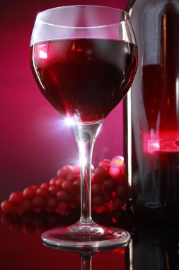 Red wine bottle with glasses and grapes clipart
