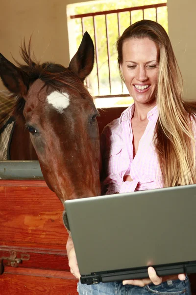 Girl and her horse check their social media site — Stock Photo, Image