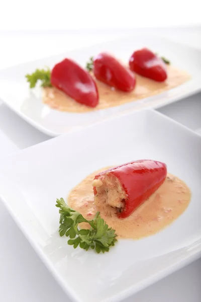 Stuffed peppers with creamy sauce — Stock Photo, Image