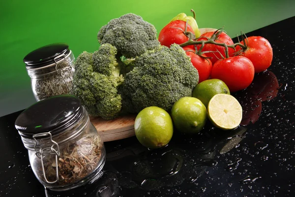 Broccoli, tomatoes, lime and spices — Stock Photo, Image