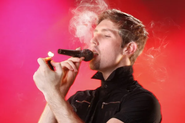 Young man with smoke microphone — 스톡 사진