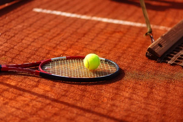 Tennisboll och racket på planen. — Stockfoto