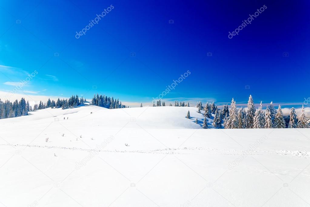 Beautiful mountain landscape and snowy paths in the snow with tourists.