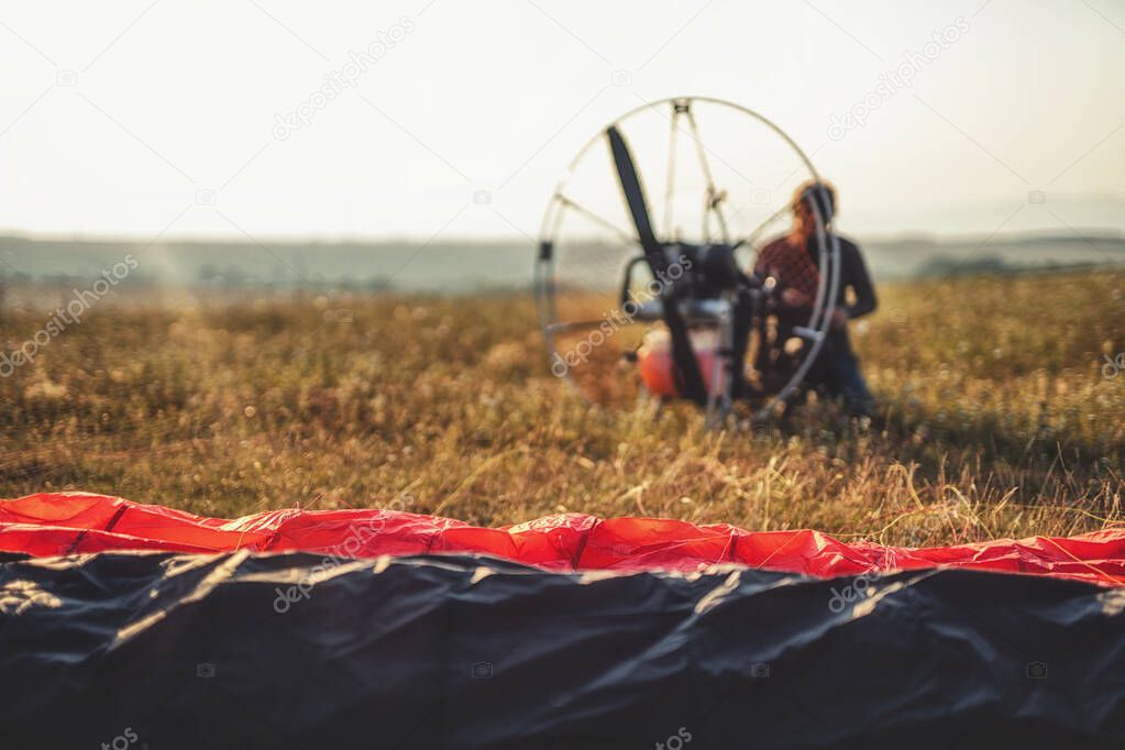 Paragliding in the mountains, paraglider on the ground.