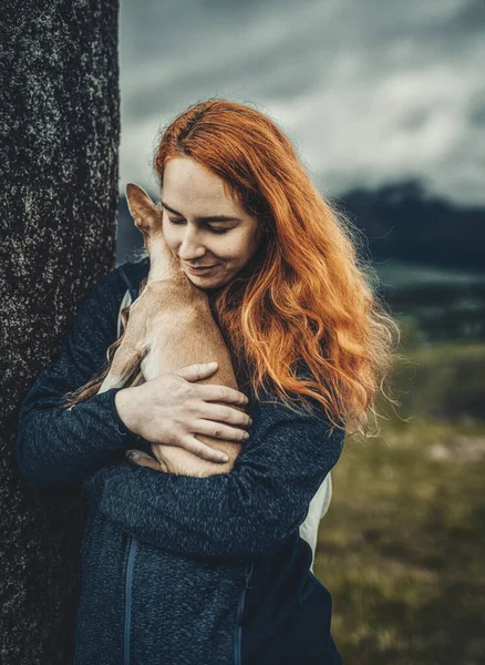 Woman with a little dog in her arms. — Stock Photo, Image