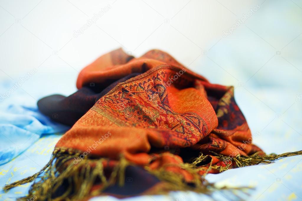 Oriental ornamental crumpled blanket on light blue background