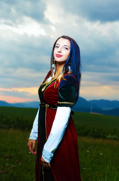 Smiling Young woman with medieval dress with sunset. Natural background. — Stok fotoğraf