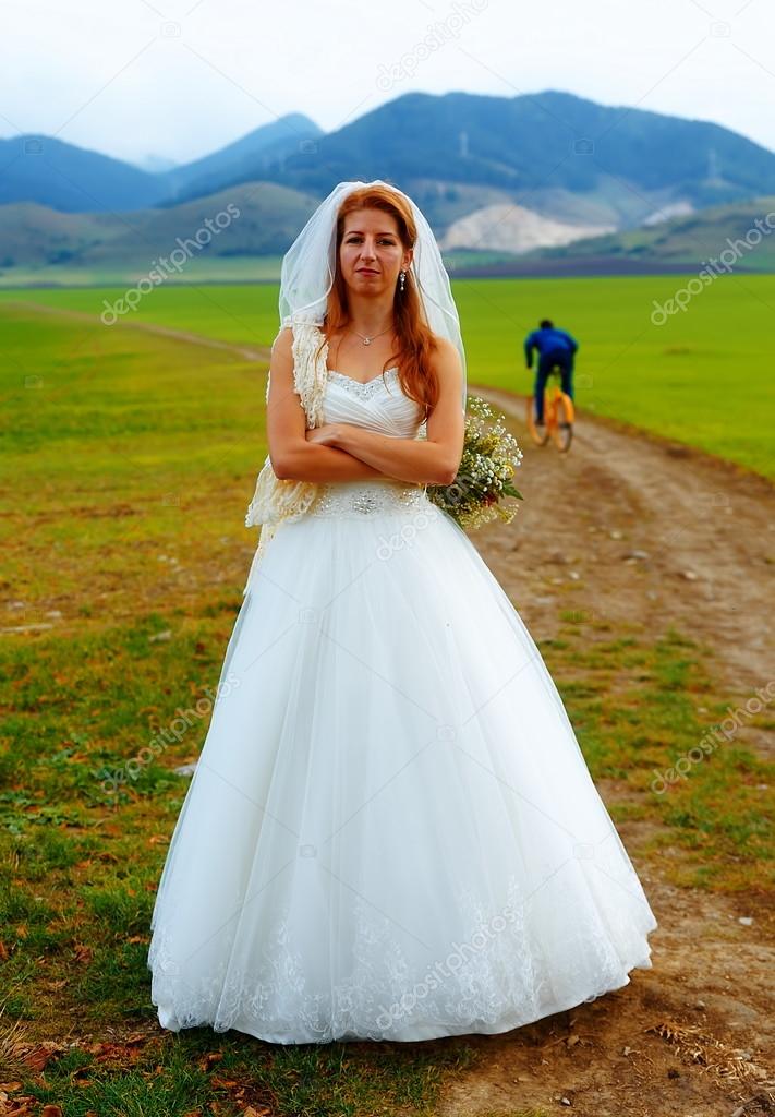 Abandoned bride and groom running away on a bike funny wedding