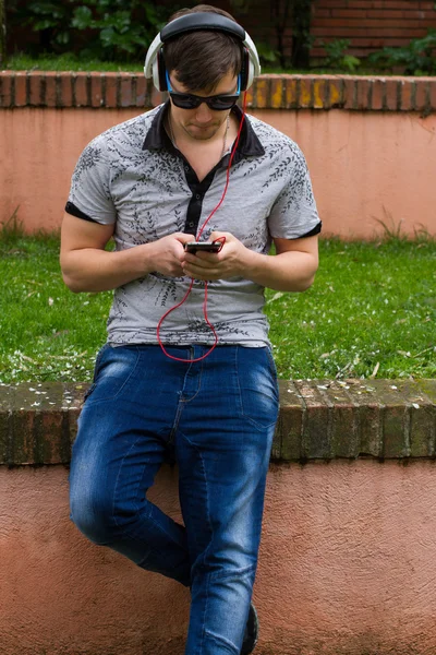 Killen med glasögon med telefon — Stockfoto