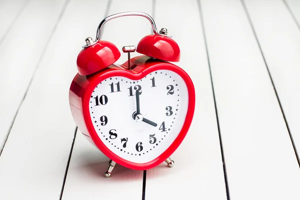 Red metal trolley and alarm clock — Stock Photo, Image