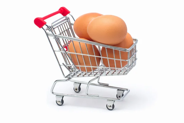 Chicken eggs in the cart on a white background — Stock Photo, Image