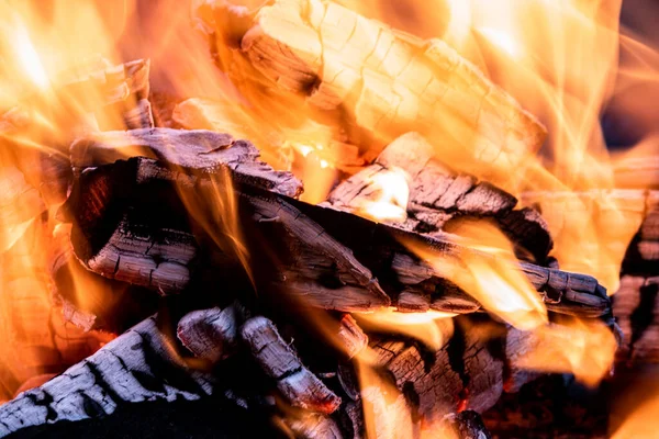 Burning fire in a small fire bowl, closeup sho of flames and burning wood in a fire bowl in late september