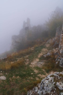 İtalya 'da Rocca Calascio, Abruzzo' daki ortaçağ şatosunun kalıntıları, sis ve bulutlar.
