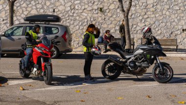 Orvinio, İtalya - 31 Ekim 2020, İtalyan Borgo Orvinio 'da ikinci koronavirüs dalgası (Covid19) sırasında durup yemek yiyen maskeli ve maskesi düşmüş motorcular,