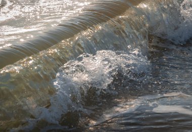 İtalya 'nın Sabaudia kentindeki Circeo parkındaki renkli deniz dalgaları ve beyaz dalgaların görüntüsünü kapat (seçici odak noktası)