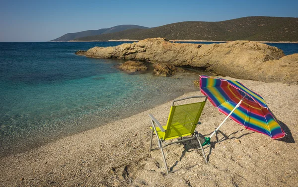 Beach umbrella and chair on beach — Stock Photo, Image