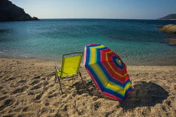 Beach umbrella and chair on beach — Stock Photo, Image